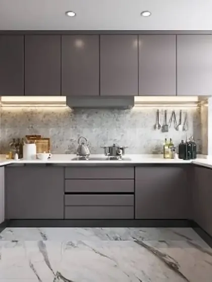 A modern U-shaped kitchen in a sophisticated matte grey finish. The marble-patterned flooring and under-cabinet lighting enhance the sleek and contemporary aesthetic.