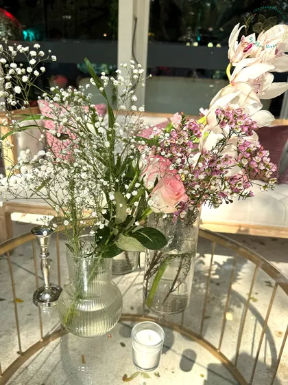 Another angle of the soft and romantic floral centerpieces. The mix of baby's breath, roses, and orchids creates a dreamy and ethereal look.