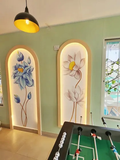 A closer view of the backlit floral murals at Essence Cafe. Each flower is hand-painted to create a delicate, graceful look that contrasts with the more graphic abstract art elsewhere in the space.