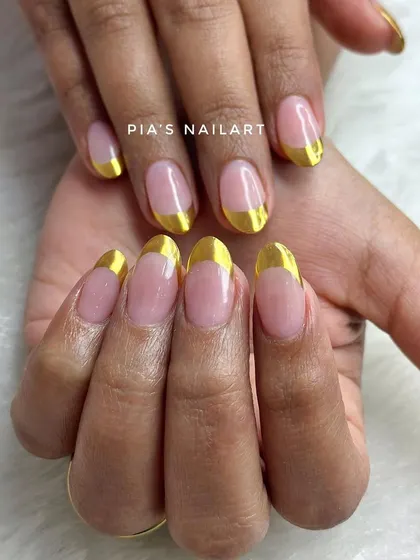 Clean and sharp. A classic French manicure gets a modern upgrade with a bold, reflective gold chrome tip.
