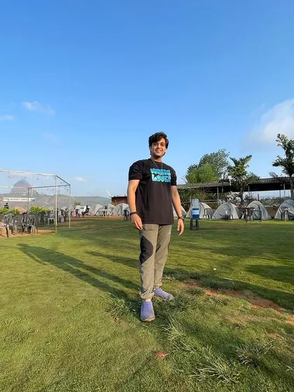 A full-length shot from the same camping location. It establishes the scene and shows a casual, comfortable style suitable for lifestyle content.