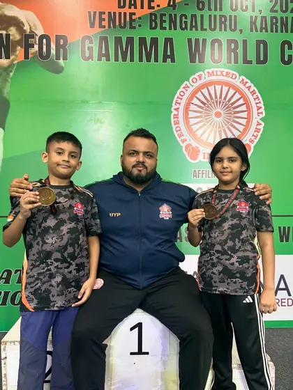The result of our hard work. Here I am with two of our junior national champions, Shivam and Mishty, after their big win. My greatest pride is seeing these kids start from scratch and rise to the top. We build champions here, and their medals are a testament to our shared journey.