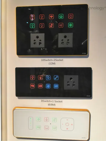 A display of various smart touch panels available at our exhibition stall. This image shows different configurations, including models with 10 switches and 2 sockets, or 8 switches and 1 socket.