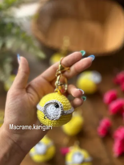 Our Minion crochet keychain is perfect for bringing a little bit of fun wherever you go. This close-up shows the detailed goggle and cheerful expression, all handmade with soft yarn.