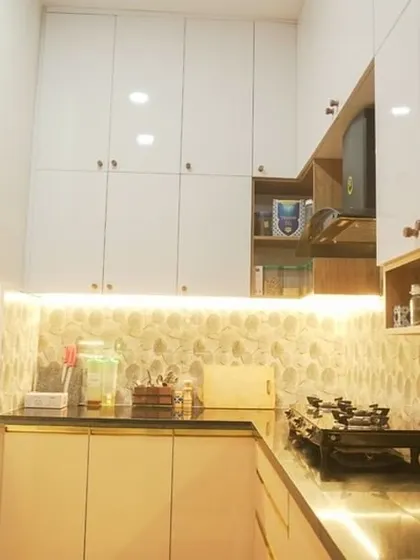 A different view of the kitchen, showing how the patterned backsplash complements the simple, clean lines of the cabinetry. The design is both stylish and practical for everyday use.