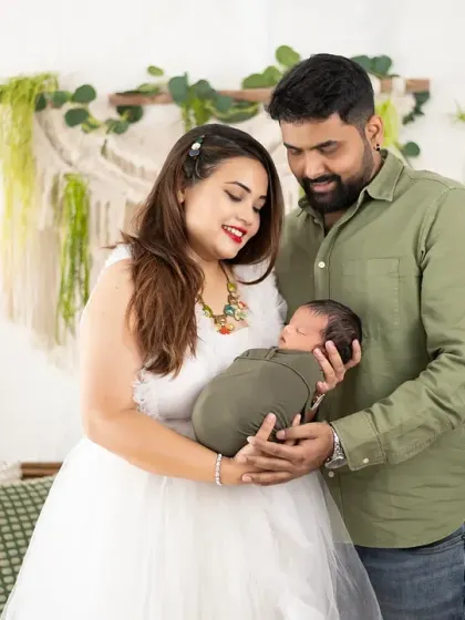 From maternity to newborn. We were so happy to capture this family's complete journey, seen here admiring their new baby in our lush, green boho setup.