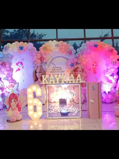 A full view of the magical doll and fairy-themed 6th birthday stage, glowing with colorful lights.