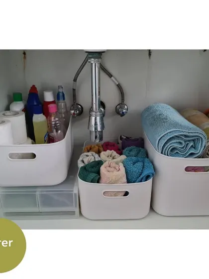 This is one of my favorite transformations. Using simple plastic bins, we created a super organized and functional under-sink area for cleaning supplies, towels, and extra toiletries.