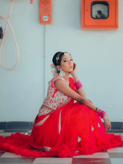 A wider shot of the same pose, showing more of the surroundings. The checkered floor and industrial elements create a unique, modern contrast with the traditional attire.