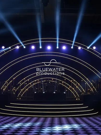 The stage is set for a spectacular Sangeet night, with concentric arches of light creating a powerful focal point and a checkered dance floor ready for the party.