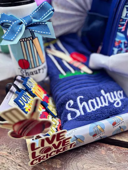 The hamper included a personalized towel and water bottle, all perfectly coordinated with the cricket theme.