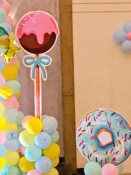 A close-up of the oversized lollipop and donut cutouts, which add a fun and whimsical touch to the Candyland theme.
