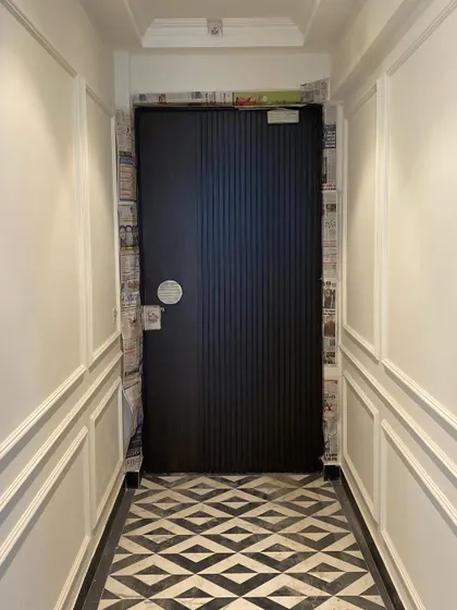The final stages of finishing the foyer, with the new door being prepped for its final coat of paint.