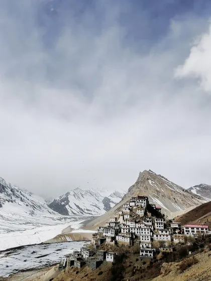 A wide-angle view of the Key Monastery against a vast, snow-covered landscape. This image shows the scale and isolation of Spiti in winter, a truly humbling sight.