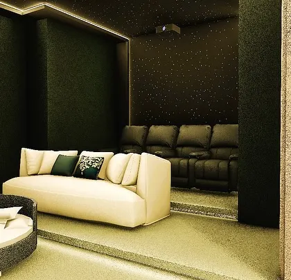 A view from behind the partition, showing how the room can be zoned into different areas: a lounge space, a bed, and the main theater seating.