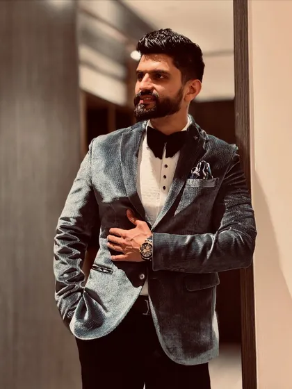 A classic velvet tuxedo look, perfect for hosting a formal gala or a sophisticated wedding reception.