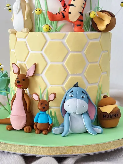 Kanga, Roo, and a sad-but-sweet Eeyore complete the scene at the base of the cake, each with their own personality.