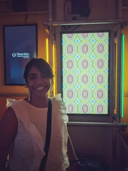 Our founder Mathura standing proudly next to her generative art piece at the Art of Code exhibition. We're thrilled to see the growing exposure for art created with code.