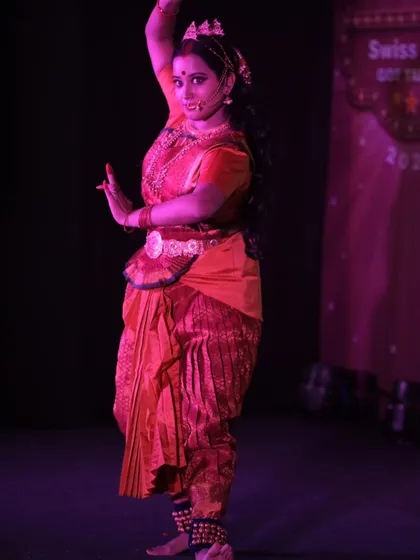 Captured in motion, this image shows how the makeup remains flawless and impactful even during a dynamic dance performance under purple and red stage lights.
