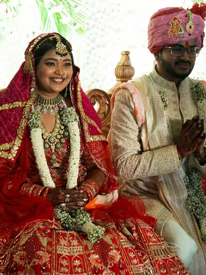 The couple seated during their wedding ceremony, surrounded by tradition and the love of their families. We work to create a setting that honors these timeless rituals.