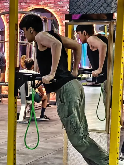 A client performs assisted dips, a fantastic exercise for building chest and tricep strength. We use resistance bands to help clients master challenging bodyweight movements.