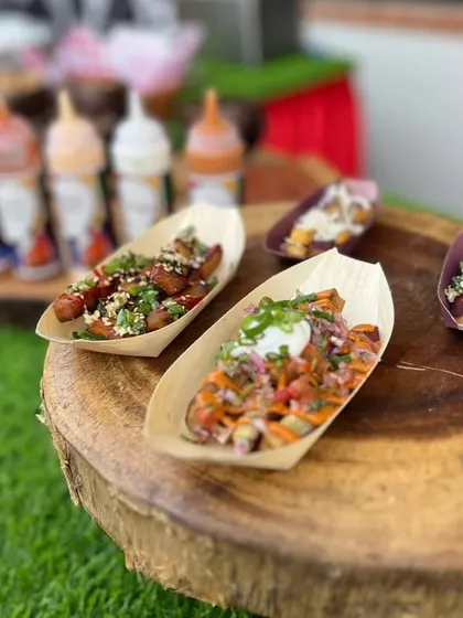 A loaded fries station from a kids' party. We offer a variety of toppings and sauces, allowing guests to customize their own perfect portion of crispy fries.