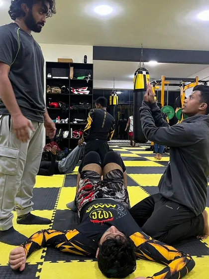 A coach films a student's technique to provide detailed feedback. We use every tool available to help our members improve.