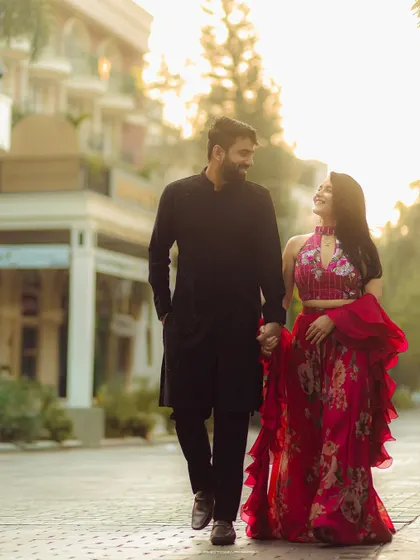 A pre-wedding shoot with a fashionable flair. The couple's stylish outfits and romantic interaction make for a beautiful, modern portrait.