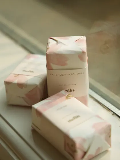 A trio of the custom-wrapped soaps for the baby announcement, showcasing the elegant and personal touch.