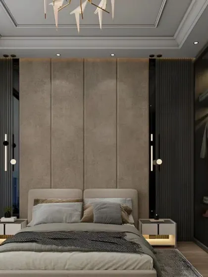 A modern bedroom featuring a floor-to-ceiling upholstered headboard and a spacious walk-in closet with glass doors.