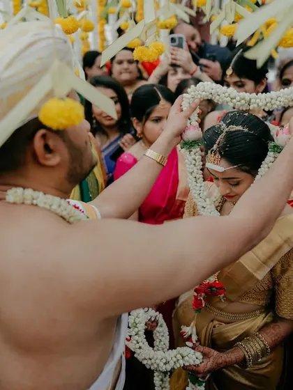 The garland exchange, or Jaimala, is the moment two souls are tied together. I focused on this intimate action, surrounded by family and flowers, to capture the sacredness of the union.