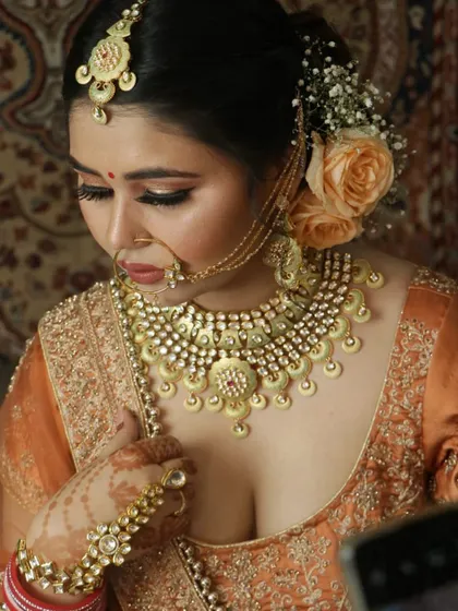 A close-up shot showing the detail of a heavy Kundan necklace on a bride. The large stones and intricate design make it a showstopper piece.