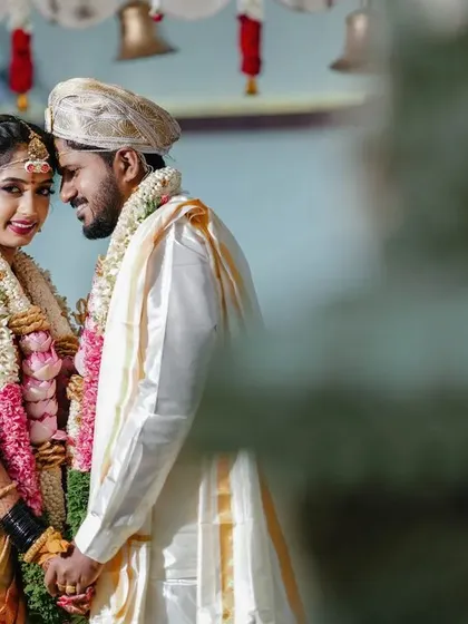 A beautifully composed portrait of a couple during their temple wedding. We use the temple's architecture to frame them, creating a timeless and elegant image.