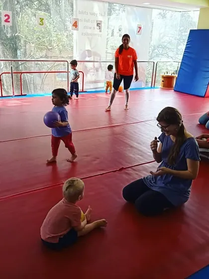 A Sunday morning class full of fun. Toddlers play with balls, which helps improve their hand-eye and foot-eye coordination in a dynamic group setting.