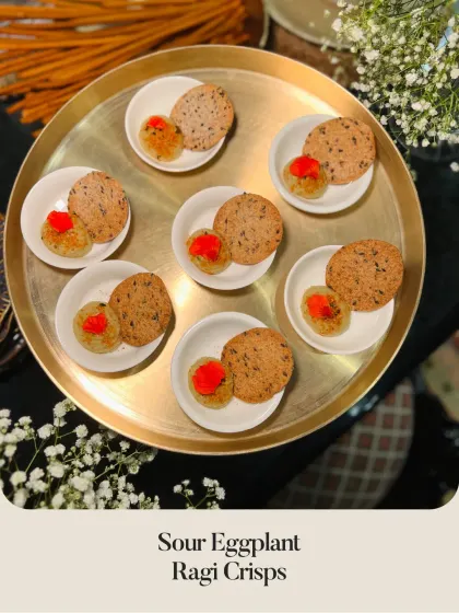 A vegetarian option: Sour Eggplant on Ragi Crisps, offering a tangy and unique flavor profile.