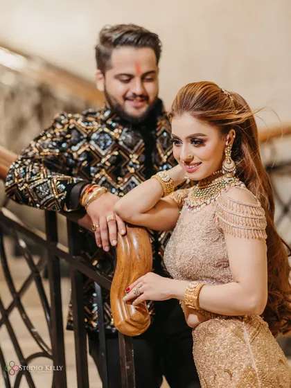 A candid and happy portrait of the couple on a grand staircase during their engagement party.
