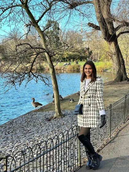 A peaceful walk in St. James's Park, London. The tailored silhouette of the coat dress gives a polished feel even in a natural, relaxed setting.
