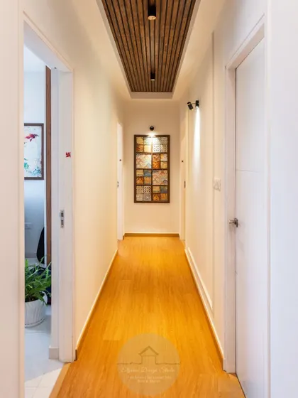 An ordinary hallway becomes a design statement. We added a warm wooden ceiling panel with integrated lighting and a custom art piece to add character, depth, and modern elegance to this transitional space.