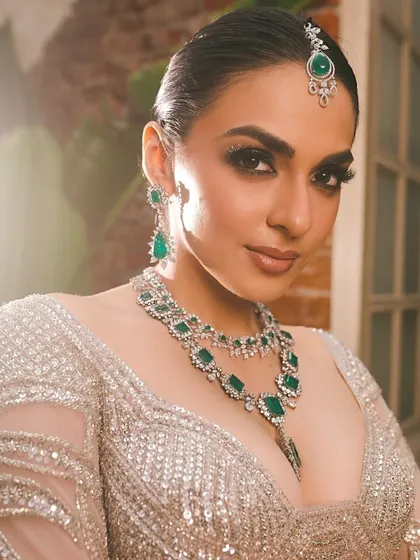 A powerful and dramatic reception look with intense smokey eyes and statement emerald jewelry, perfect for making an entrance.