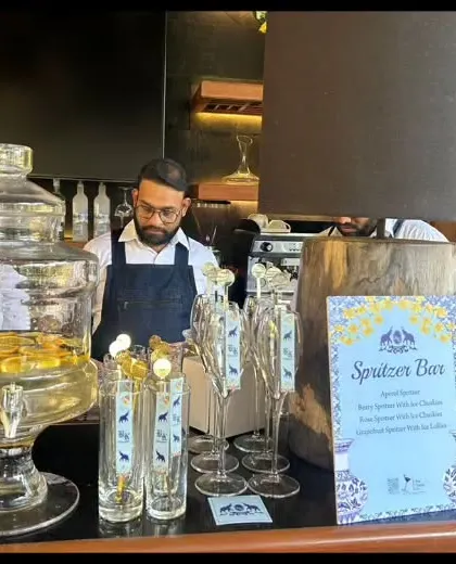 A dedicated Spritzer Bar for a daytime event. We provide large glass dispensers of pre-mixed spritzers and a variety of fresh fruit garnishes for guests to customize their drinks.