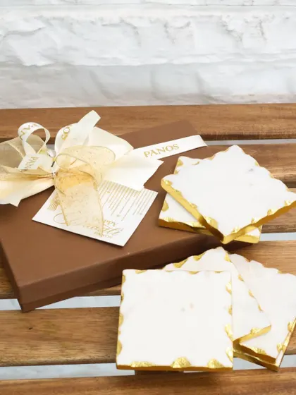 Our white marble coasters, packaged in a classic Panos gift box with a golden ribbon, offer a touch of everyday luxury. It is a perfect, ready-to-give present for any occasion.