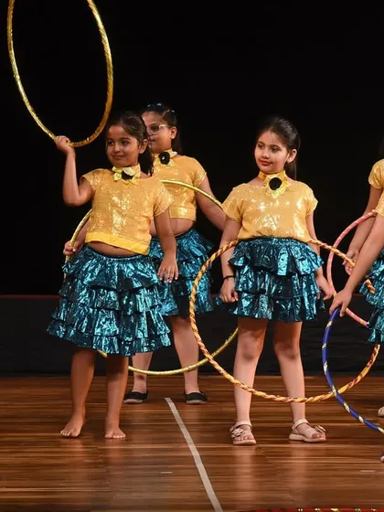 The girls holding their final poses, hoops in hand, after a successful and mesmerizing performance.