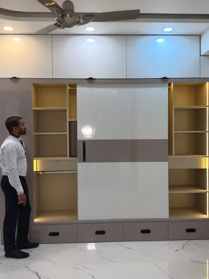 Another angle of this functional sliding wardrobe, showing how the doors glide to reveal different sections. The combination of open shelves and drawers inside allows for versatile organization.