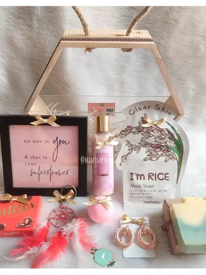 A dreamy birthday hamper for her, featuring a small dreamcatcher, a motivational quote frame, a handmade soap bar, and other self care goodies. The hexagonal box with a jute handle adds a unique, rustic touch.
