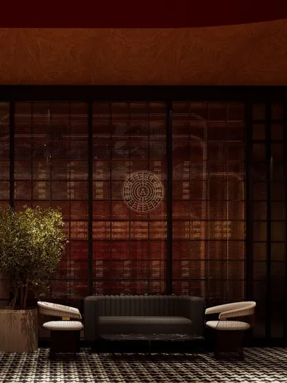 The waiting area in the Koko suite, designed with a dark, moody palette, houndstooth flooring, and a dramatic glass partition to create a sense of anticipation.