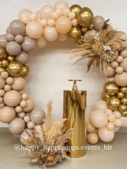 A full circle of celebration. This circular balloon arch in neutral and gold tones creates a stunning focal point, with a single gold plinth ready for the birthday cake.