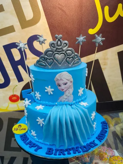 A 3kg two-tiered Frozen cake in blue, with a fondant dress and a silver tiara for Queen Elsa.