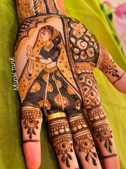 A close up of the bride's portrait from a full bridal set. The figure is framed by an ornate arch, and the fingers have delicate, matching patterns.