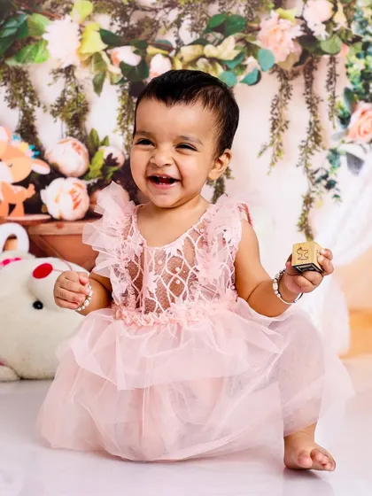 With a joyful laugh and a playful pose, this little princess is ready for her own Disney movie. A perfect capture of her sparkling personality.