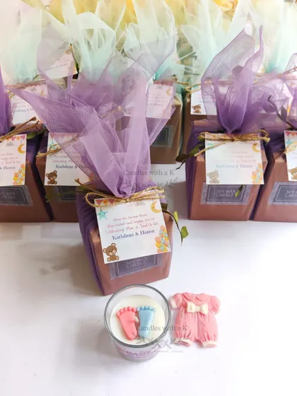 A beautifully arranged baby shower gift box with a baby feet candle and a baby onesie fridge magnet, ready for Karishma's event in Mumbai.